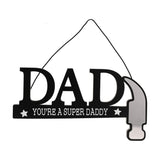 Wooden hanging wall plaque spelling DAD in black, with "You're A Super Daddy" and white stars below, the bar forming a hammer handle with a silver mirror-effect head, on a plain white background.