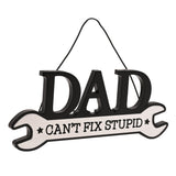 Wooden spanner-shaped wall plaque with "DAD" in bold black letters above "CAN'T FIX STUPID" on a white handle with black stars, hung on a cord against a plain white background.