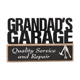 Wooden standing plaque reading Grandad's Garage in black cut-out letters, with a black panel reading Quality Service and Repair and a silver tool charm, on a white background.