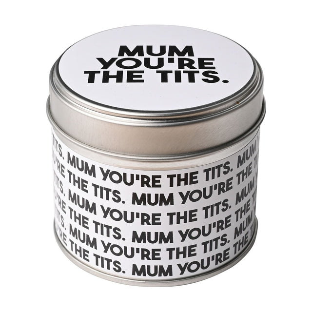 Round lidded tin scented candle in silver metal with white label printed "Mum You're The Tits" in bold black text, shown on a plain white background.