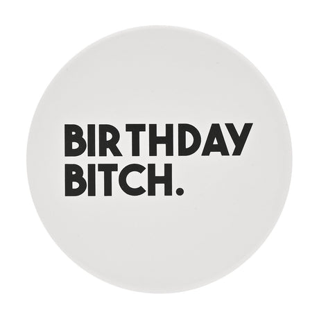 Round white ceramic coaster with bold black "BIRTHDAY BITCH." text in capitals, matt finish, shown on a plain white background.