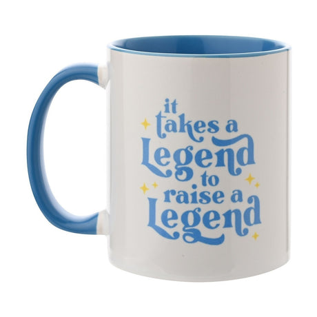 White glazed stoneware mug, 11oz, with blue interior and handle, featuring blue "It Takes A Legend To Raise A Legend" script and yellow stars, on a plain background.