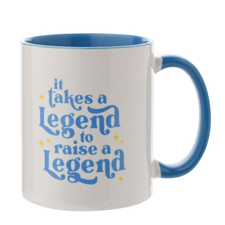 White glazed stoneware mug with blue interior and handle, printed with "it takes a Legend to raise a Legend" in blue script and yellow stars, on a white background.
