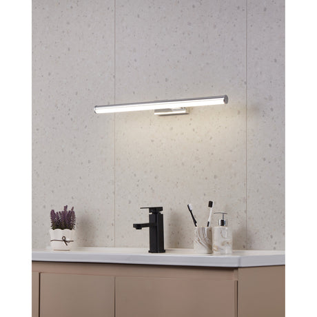 Wenelle LED Bathroom Wall Light 60cm in chrome, mounted above a bathroom vanity with a horizontal bar and opal diffuser lighting a countertop with black tap and accessories.