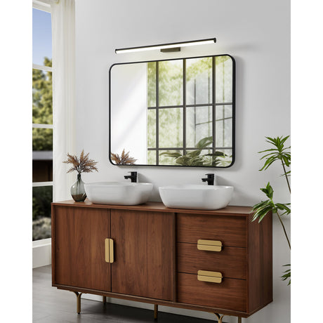 Wenelle LED Bathroom Wall Light 78cm in black, mounted above a square black-framed mirror over a walnut double-sink vanity with brass handles.