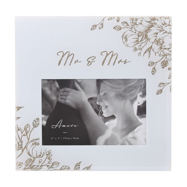 Square glass photo frame in pale grey with gold glitter floral corners and "Mr & Mrs" script above a 6 x 4in landscape opening, shown with a wedding photo.