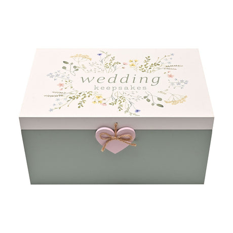 Rectangular wooden wedding keepsake box with sage green base and white lid featuring a pastel wildflower print, "wedding keepsakes" text, and a pink heart accent on the front.