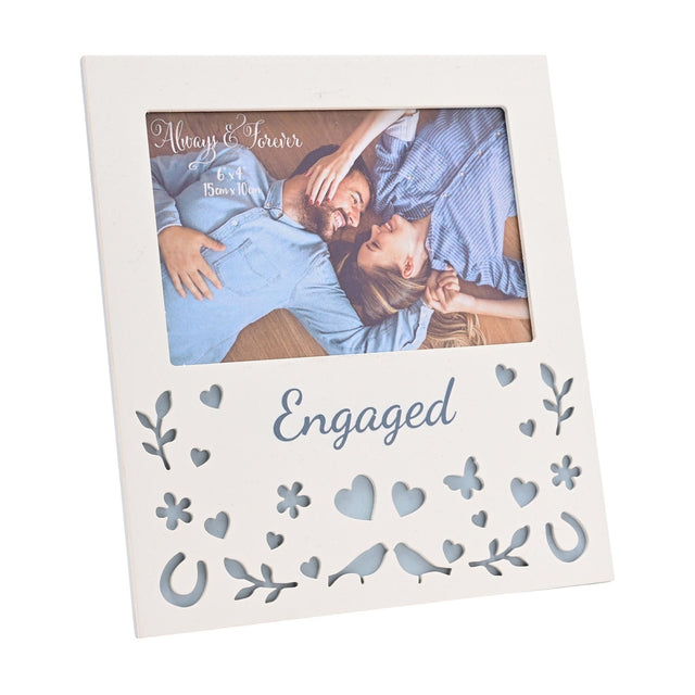 Cream wooden 6 x 4in photo frame with "Engaged" script below the picture window, its lower half cut through with hearts, flowers, a butterfly, leafy sprigs, horseshoes and facing birds.