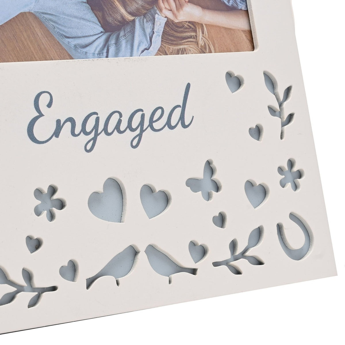 Cream wooden Engaged photo frame with 6 x 4in landscape photo window, grey-blue script text, and cut-out hearts, flowers, butterfly, birds and horseshoes below.