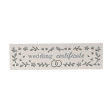 White wooden wedding certificate keepsake box with cut-out hearts, flowers, birds and linked rings in grey, "wedding certificate" in blue lettering, shown on a plain background.