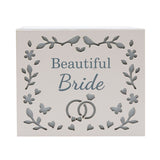 White wooden rectangular keepsake box with "Beautiful Bride" text, cut-out floral wreath, lovebirds, and interlinked wedding rings design, on a plain background.