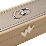 Close-up of the ivory wooden Wedding Certificate keepsake box, rectangular with a silver-plated plaque, intertwined ring motif, and a heart detail on the hinged lid edge.