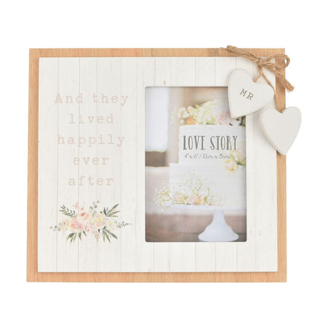 White wooden photo frame with "And they lived happily ever after" text, floral spray, and two hanging hearts, one marked MR, holding a Love Story 6x4in photo.