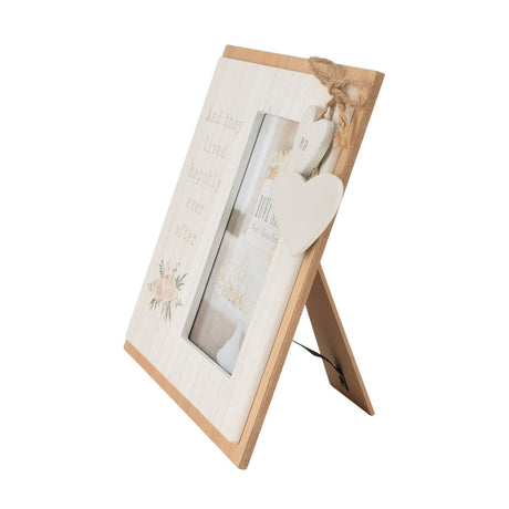 Wooden 6x4in photo frame with white board-effect front reading And they lived happily ever after, floral accent, natural wood edge, and two hanging white hearts tied with twine.