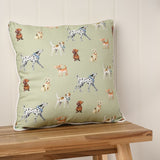 Square cushion, 42cm x 42cm, in lime green with a scattered dog print and cream piped edge, shown on a wooden bench against a panelled wall.