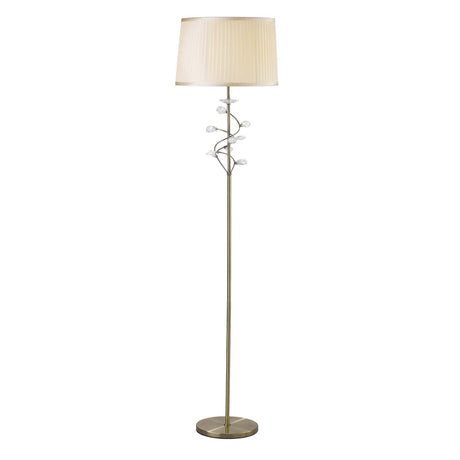 The Willow 1 Light Crystal Floor Lamp features an antique brass finish, a round base, slender stand, cream shade, and decorative crystal accents branching beneath the shade.