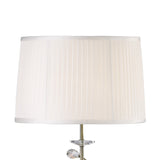 A close-up of the Willow 1 Light Crystal Floor Lamp in brass, featuring a white pleated shade and an elegant crystal base, with part of the stylish silver-finished bottom visible.