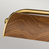A close-up of the Winchfield 4 Light Large Picture Light, featuring an oak effect finish and sleek aged brass accents, set against a neutral gray background.