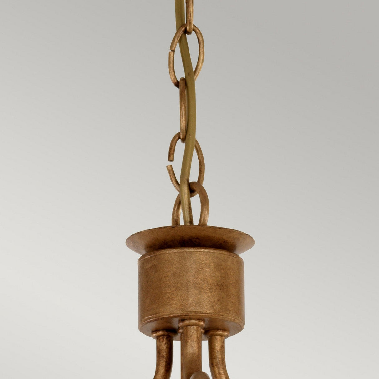 Close-up of a vintage-style Windsor 3 Light Chandelier in gold patina, featuring a decorative chain and cylindrical canopy against a plain background.