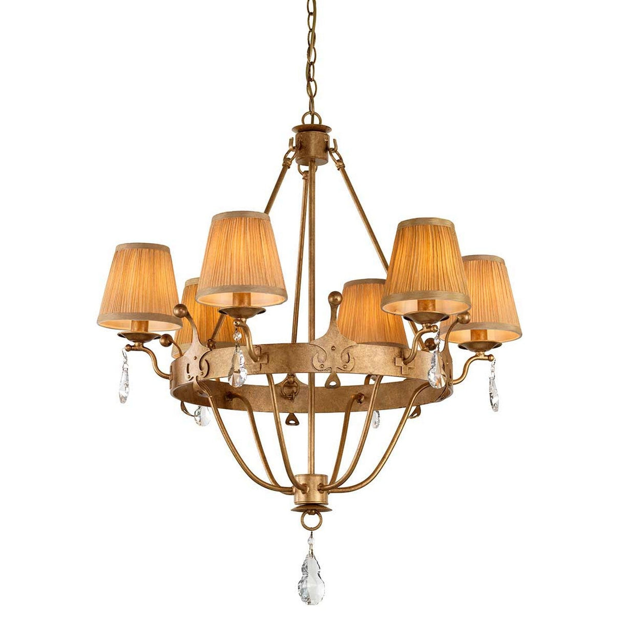 The Windsor 6 Light Chandelier - Gold Patina features a sophisticated gold patina finish with six light fixtures adorned with beige lampshades. Graceful crystal embellishments dangle beneath the shades and from the base, adding an elegant touch.