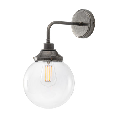 Wistella Glass Globe Wall Light IP44 - 20cm clear round globe shade on a bent brass arm with circular backplate, shown with LED filament bulb on a white background.