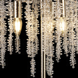 Close-up of the Wisteria 3 Light Table Lamp in gold, featuring clear crystal clusters beside glowing, dimmable bulbs. Set against a black background, the crystals reflect light to create a stunning shimmering effect.