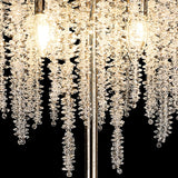 Close-up of the Wisteria 4 Light Crystal Floor Lamp in French Gold, featuring spiral strands of clear crystals illuminated by warm bulbs against a black background, creating elegant ambient lighting.
