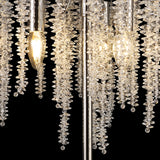 Close-up of the Wisteria 3 Light Table Lamp in nickel, featuring hanging clusters of clear crystals and glowing bulbs. The faceted crystals reflect ambient light, producing a sparkling effect against a black background.