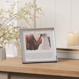 Silver metal square photo frame, 6 x 4in, with white mount reading "Mr & Mrs" in script above a wedding photo, displayed on a wooden table.