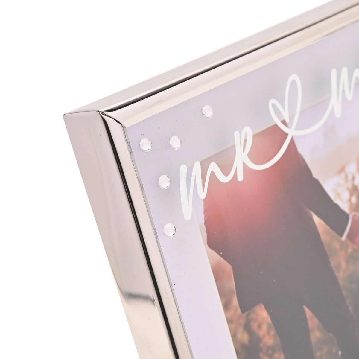 Close-up of the Mr & Mrs Square Word Metal Photo Frame 6 x 4in in silver, showing the polished corner, white mount with script text, and a wedding photo inside.