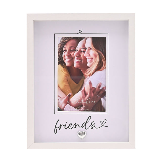 White rectangular photo frame with grey mount, "friends" script text and small silver heart, displaying a 6 x 4in photo of three smiling women.