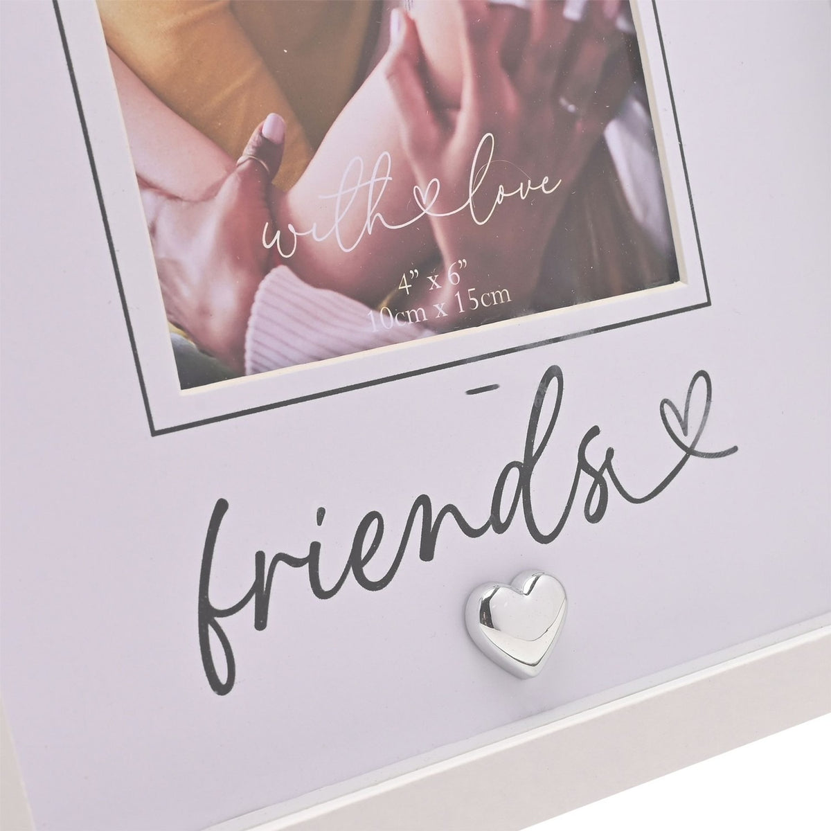 White photo frame with pale grey mount, "friends" script and a small silver-tone heart, holding a 6 x 4in photo of joined hands.