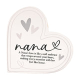 Freestanding clear acrylic heart decoration printed with "nana" in black script, a looped heart accent, grey heart motifs, and a nana's love verse below, on a plain white background.