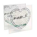 Clear glass double-panel tealight holder featuring white heart cluster, black script "mum," and surrounding sentimental words, on a glass base against a white background.