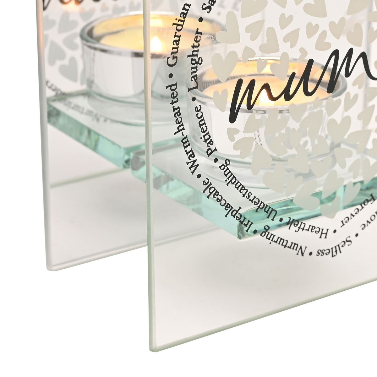 Close-up of the Mum Heart Double Panel Glass Tealight Candle Holder with lit tealights, tiny white hearts, mum in black script, and words like warm-hearted and guardian.