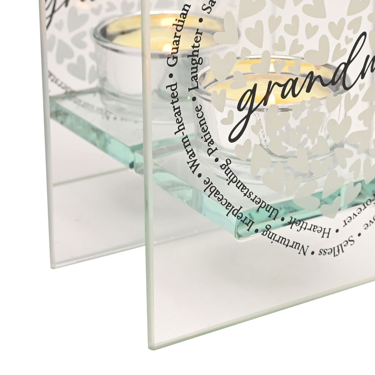 Close-up of the Grandma Heart Square Glass Tealight Candle Holder, clear glass with white heart pattern, script "grandma" text, and a ring of printed words like Guardian, Understanding, and Nurturing.