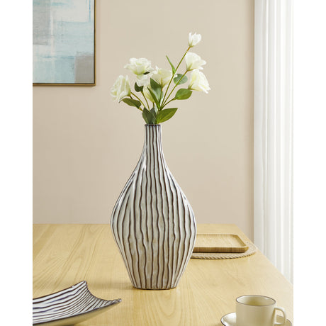 Wormiston Ceramic Vase 45.2cm in white and brown with wavy ridged lines, holding white flowers on a wooden dining table.