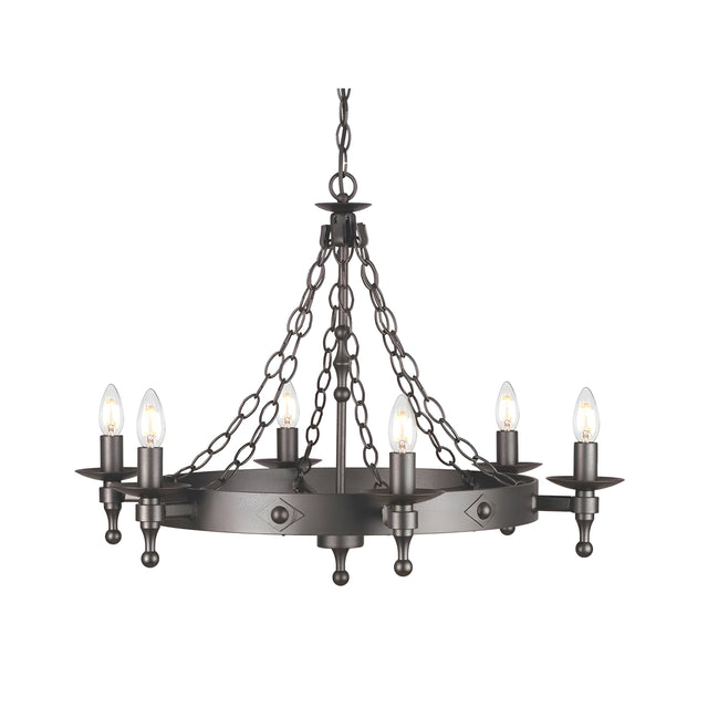 The Warwick 6 Light Chandelier in Graphite Black creates a medieval ambiance with its circular frame and six candle-shaped bulbs. The fixture, suspended by chains, features an industrial and rustic design.