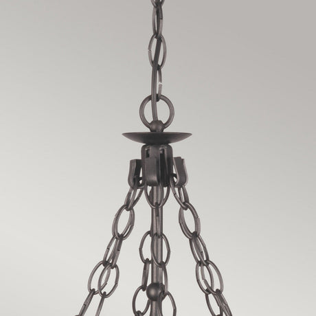 Close-up of the Warwick 6 Light Chandelier in graphite black, crafted from wrought iron with several interconnected chains. The design is minimalist and modern, set against a plain grey background.