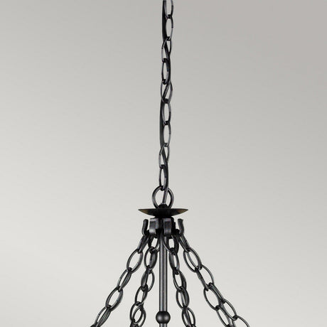 A detailed view showcases the rustic elegance of a black metal chain supporting a wrought iron chandelier against a light gray background. The chain loops gracefully, leading to the Warwick 8 Light Chandelier - Graphite Black, featuring its numerous branching links.