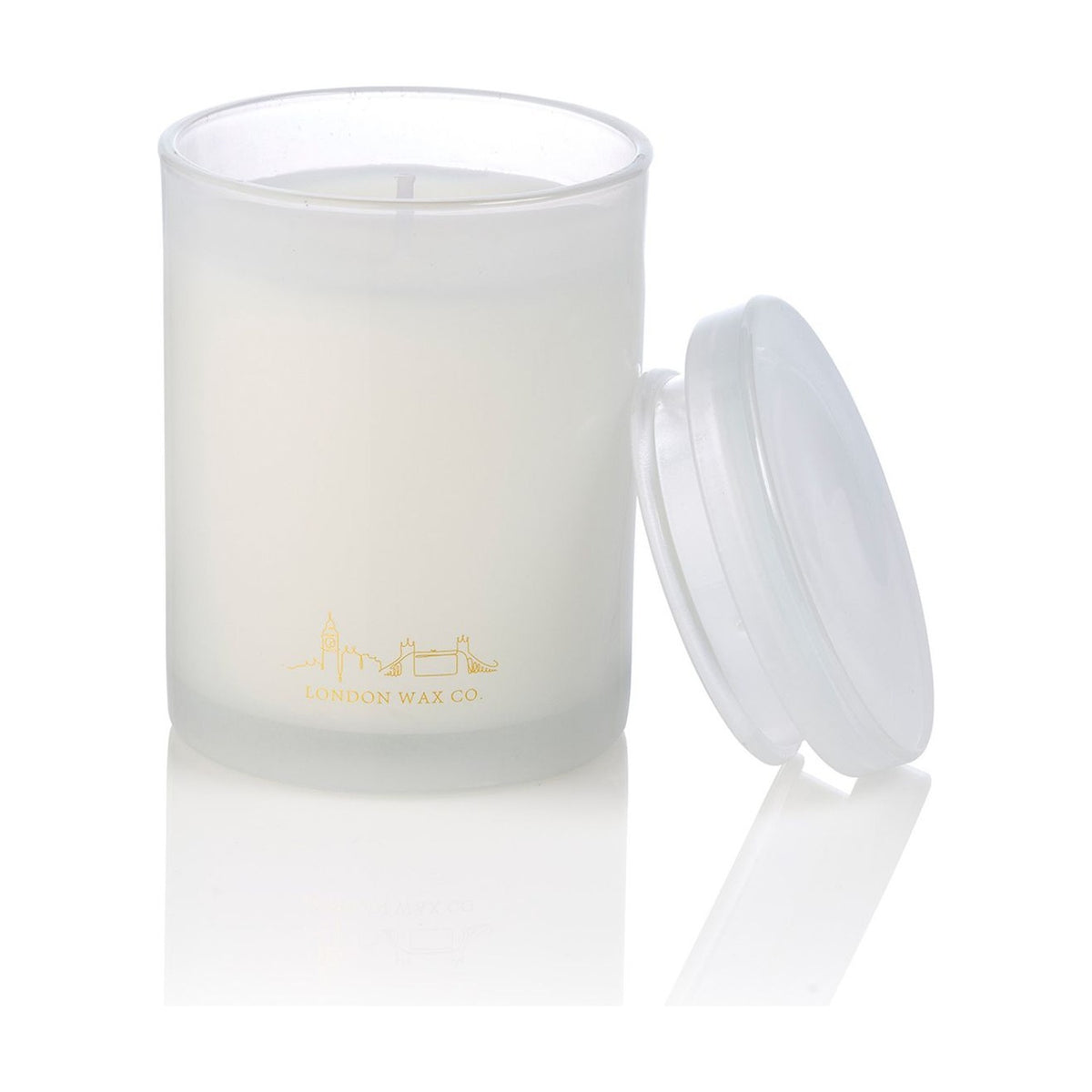 Floral Fields 1 Wick Scented Candle, round frosted glass jar with white wax and gold London skyline design, clear lid resting beside it, on a plain white background.