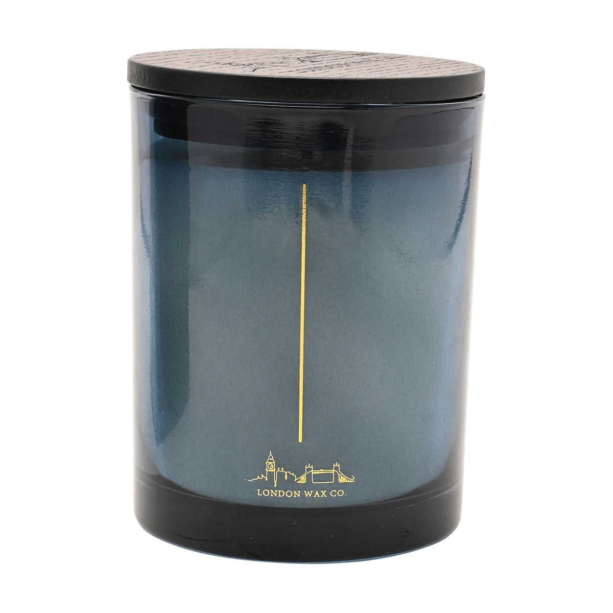 Dream & Cocoon round scented candle in a blue glass vessel with black lid, gold wick line and London skyline design, on a plain white background.