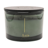 Round three-wick scented candle, 397g, in a smoky green glass vessel with black lid, gold skyline line art, on a plain white background.