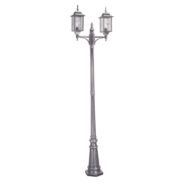 The Wexford 2 Light Lamp Post - Black/Silver is a tall, ornate street lamp with a vintage design, featuring two lanterns mounted on an intricately detailed decorative metal post. Ideal for outdoor lighting, this sophisticated fixture enhances any setting with charm and elegance.