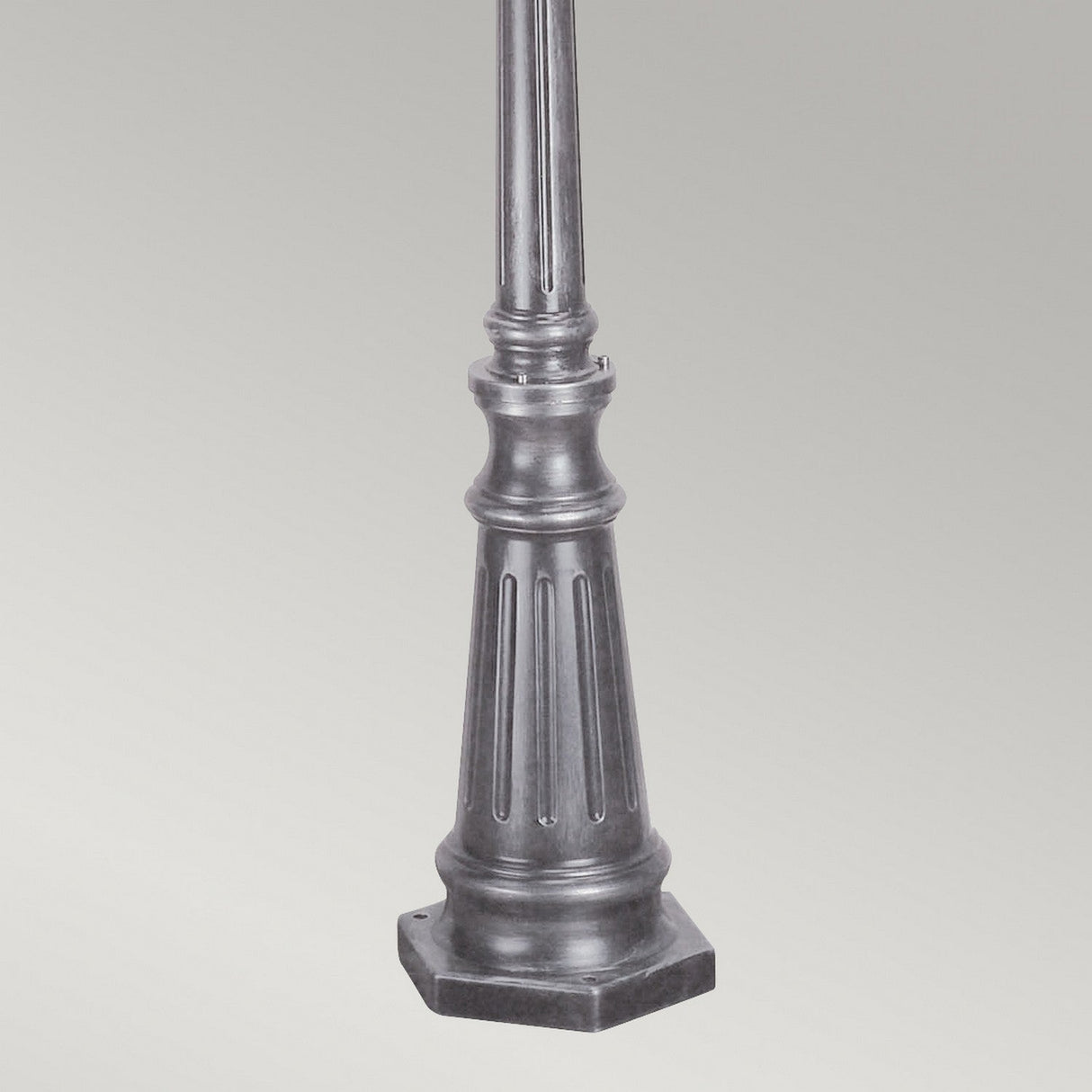 The Wexford 2 Light Lamp Post - Black/Silver showcases a robust black metal base with vertical grooves, ideal for outdoor lighting. Its sleek design contrasts beautifully against a light gray background, offering an elegant touch to any setting.