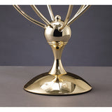 A close-up of the Xeena 3 Light Crystal Table Lamp’s shiny French gold base and lower structure, reminiscent of a modern lamp or award, set against a plain gray background.