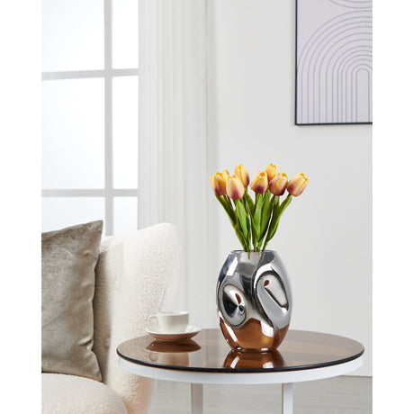 Xiporai 19.8cm chrome glass vase with dimpled, mirror-bright ovoid body holding orange tulips, shown on a round side table in a living room.