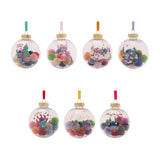 Set of 7 clear round pompom baubles with coloured hanging ribbons, each filled with mixed pom poms and featuring a different printed Stitch Christmas design, on a white background.