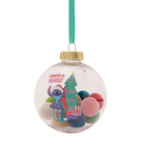 Clear round bauble Christmas decoration with gold cap and teal ribbon, filled with mixed pastel pompoms and a Stitch "Santa's Here!" design with presents and a tree.