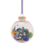 Clear round Stitch Christmas bauble filled with coloured pompoms, printed with an ice-skating Stitch design and "Winter Wonderland" text, hung on a lilac ribbon against a white background.